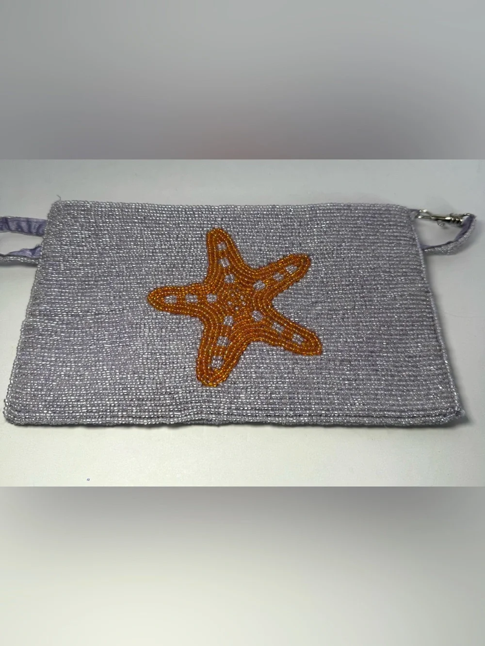 Viral K.C. Malhan hand-beaded starfish wristlet clutch